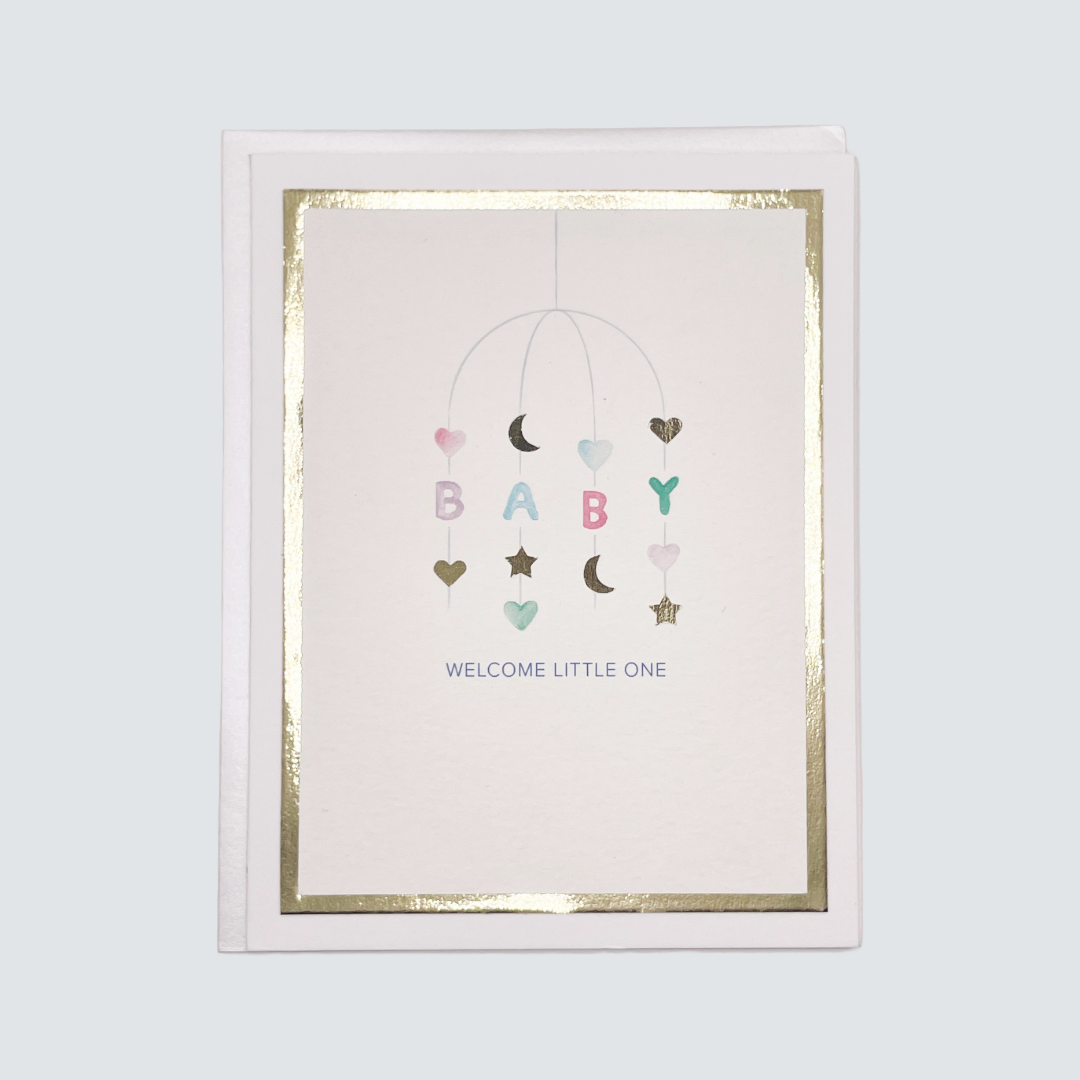 Handmade neutral baby card with watercolor mobile artwork and gold foil frame, blank inside.