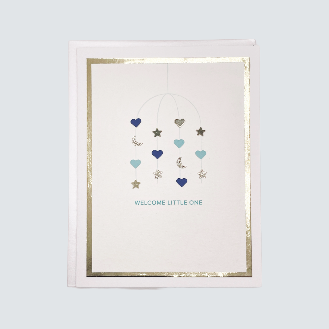Handmade blue baby card with watercolor mobile design and gold foil border, blank inside.