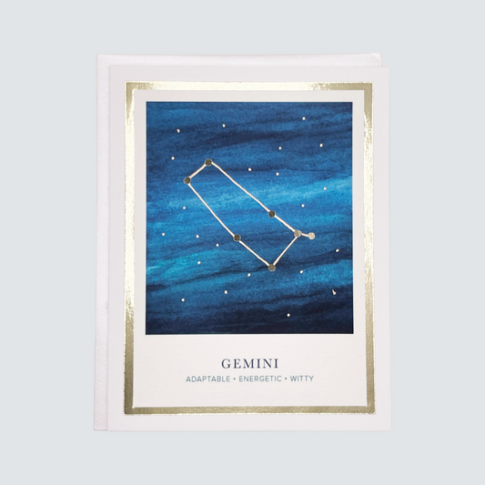 This image features a beautifully crafted Gemini Zodiac Card. The card showcases a stunning hand-watercolored artwork of a blue sky adorned with golden stars, highlighting the zodiac sign of Gemini.