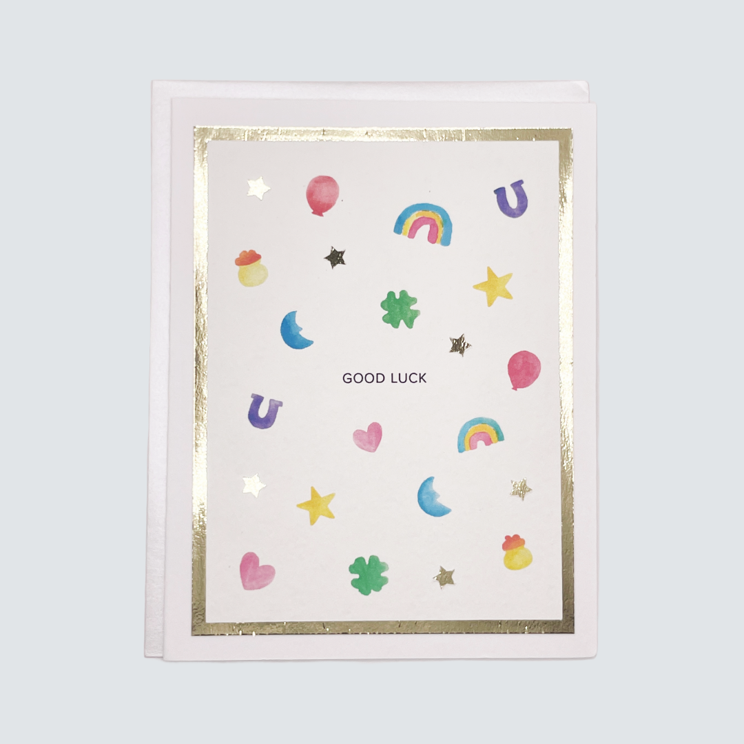 Handmade good luck card with watercolor charms and gold foil border, blank inside on FSC-certified cardstock.