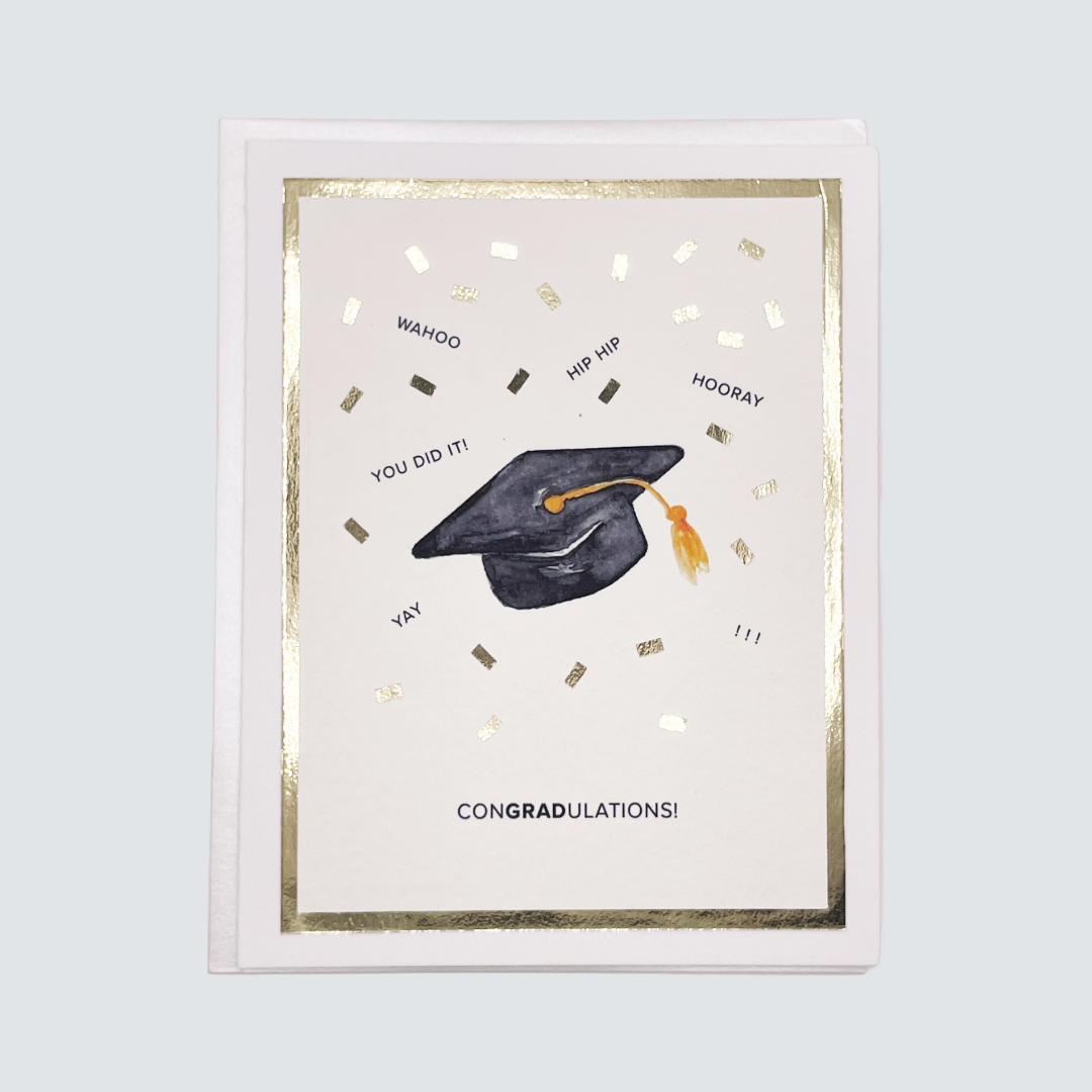 Handmade graduation card with cap and confetti watercolor artwork and gold foil accents, blank inside.