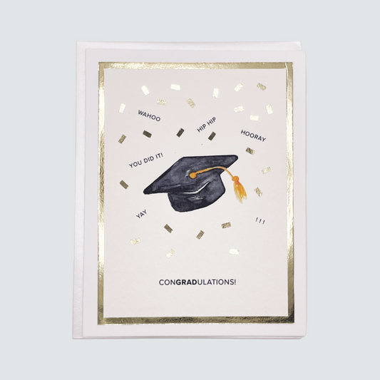 Handmade graduation card with cap and confetti watercolor artwork and gold foil accents, blank inside.