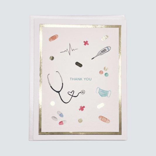 Handmade healthcare thank you card with stethoscope and medical illustrations in gold foil, blank inside on FSC-certified cardstock.