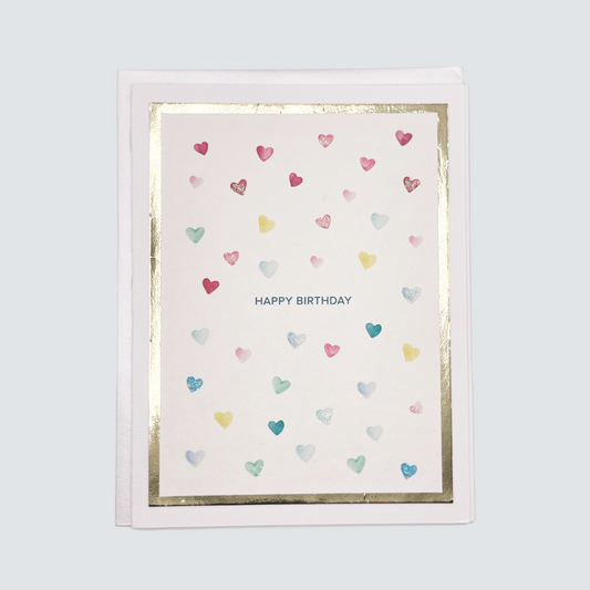 Handmade birthday card with watercolor heart design and gold foil border, blank inside.