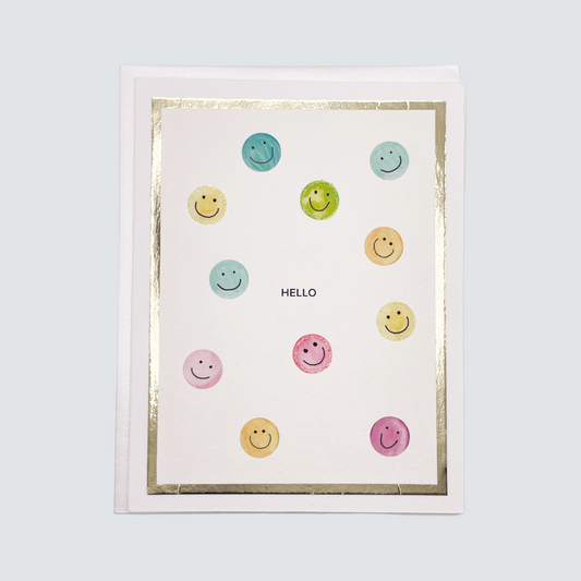 Handmade hello greeting card with watercolor smiley faces and gold foil accents, blank inside on FSC-certified cardstock.