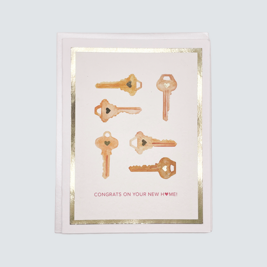 Handmade housewarming card with gold foil key artwork, blank inside on FSC-certified cardstock.