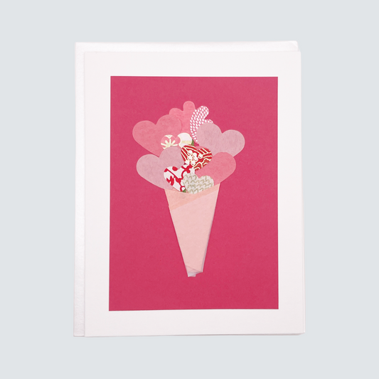 Handmade origami bouquet card with washi paper flowers and red cardstock cone, blank inside.