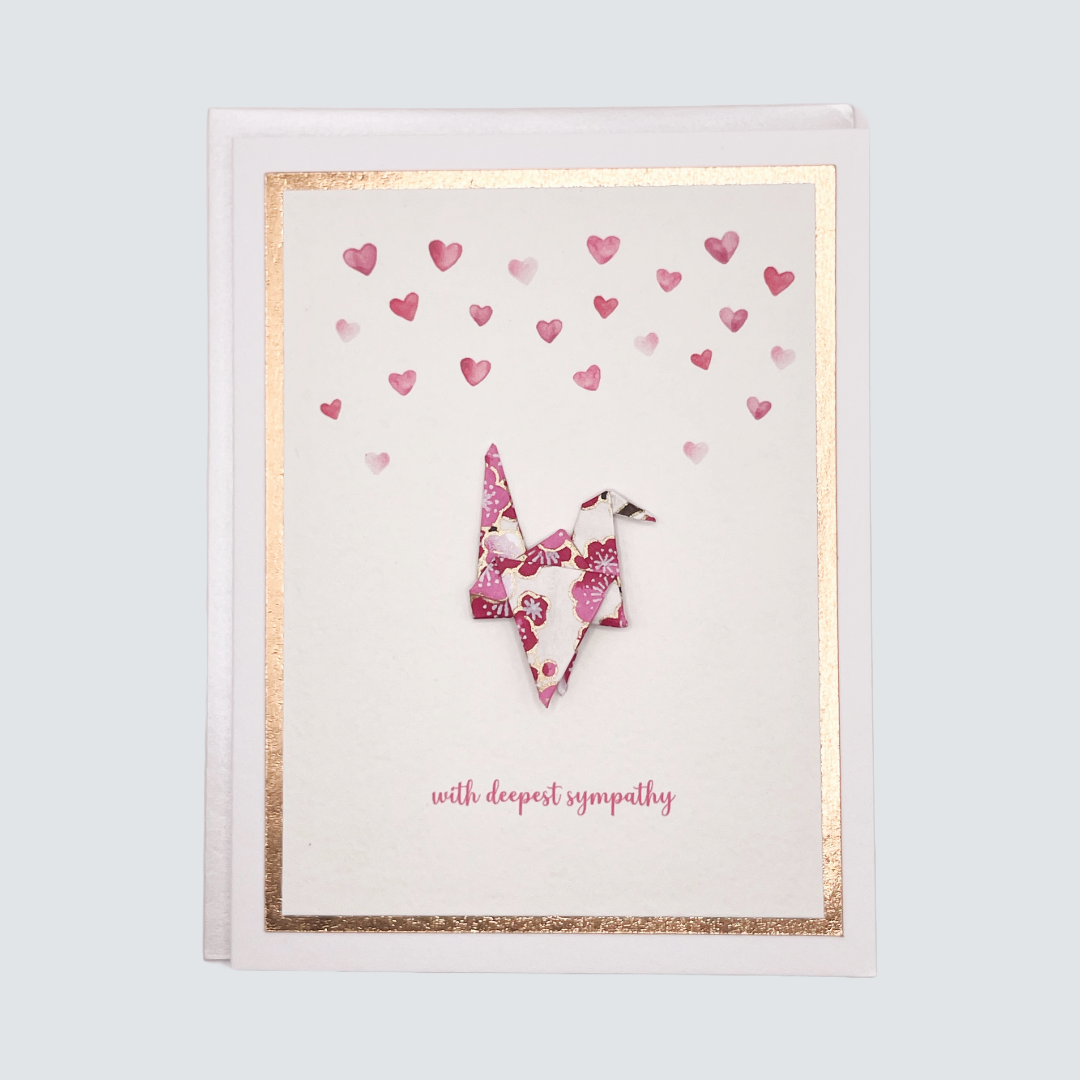 Handmade sympathy card with watercolor origami crane and rose gold foil accents, blank inside.