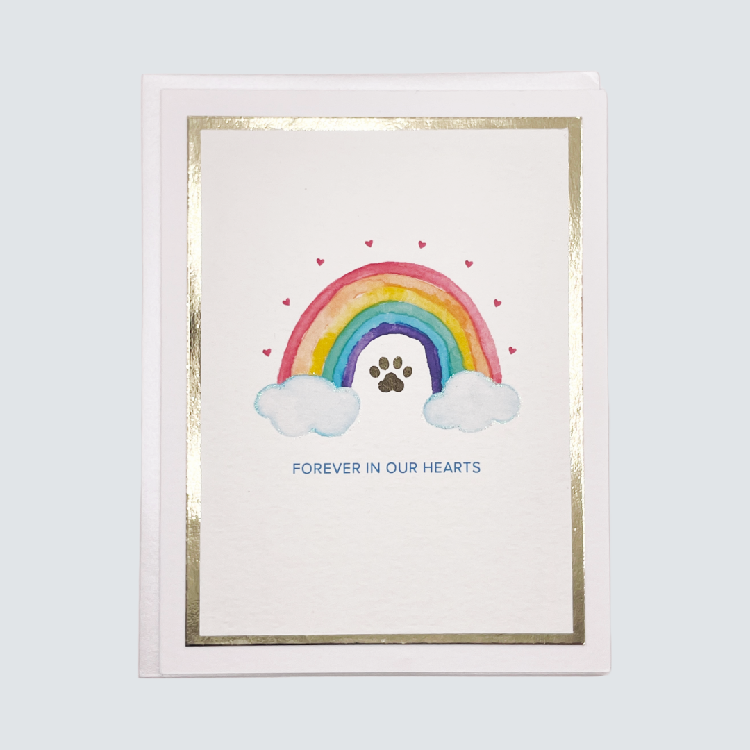 Handmade pet loss sympathy card with rainbow and paw print design, gold foil border, blank inside.