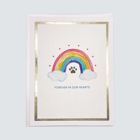 Handmade pet loss sympathy card with rainbow and paw print design, gold foil border, blank inside.