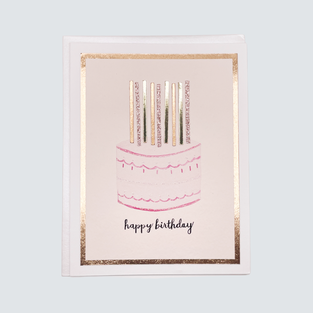 Handmade pink birthday cake card with watercolor candles and rose gold foil accents, blank inside on FSC-certified cardstock.