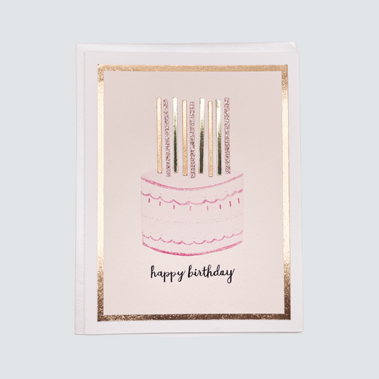 Handmade pink birthday cake card with watercolor candles and rose gold foil accents, blank inside on FSC-certified cardstock.
