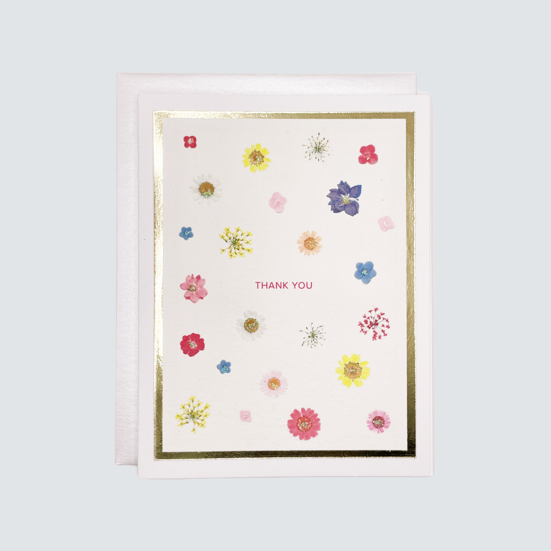 Greeting card with floral designs and 'Thank You' text on a light blue background