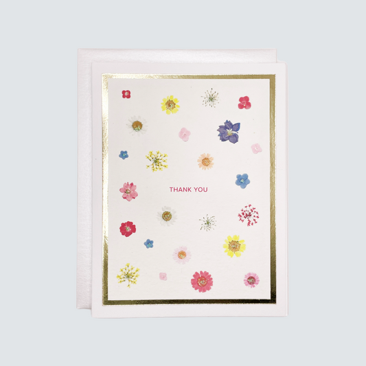 Greeting card with floral designs and 'Thank You' text on a light blue background