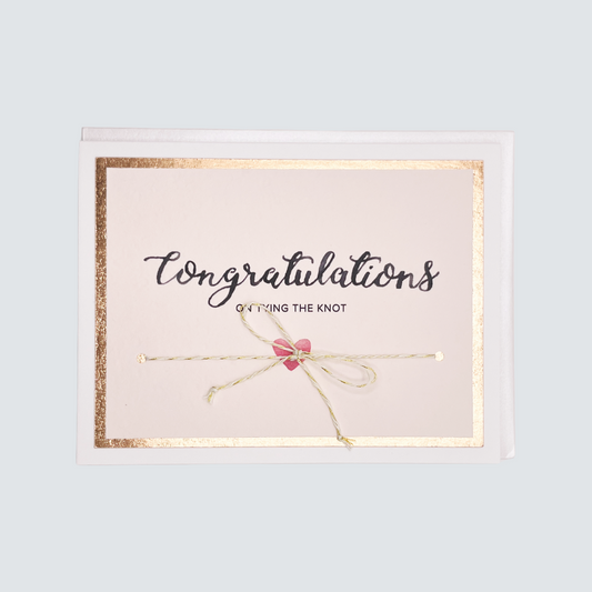 Handmade wedding card with “Tying the Knot” message, rose gold foil border, and twine embellishment, blank inside.