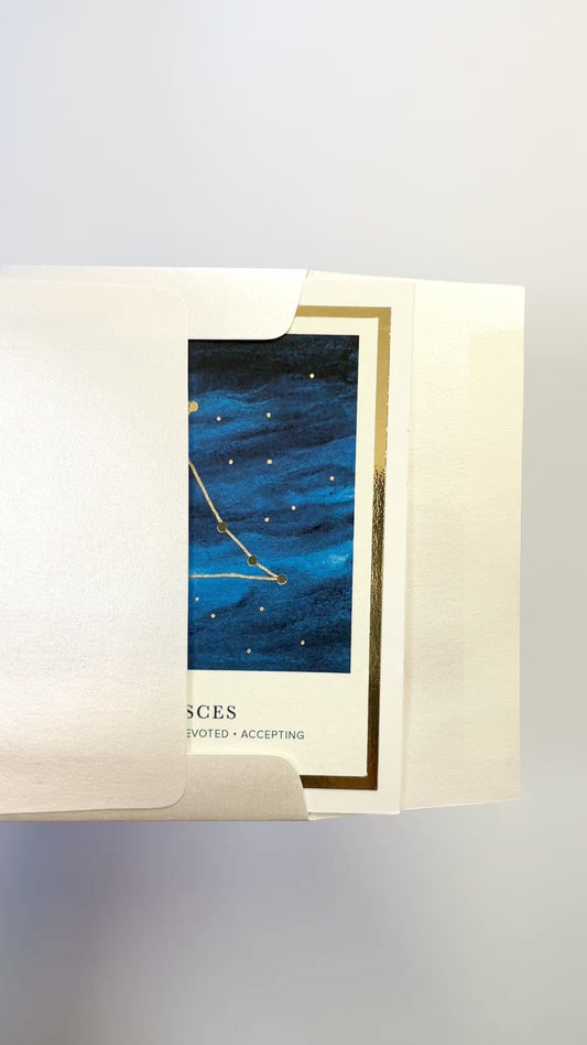 Handmade Pisces zodiac constellation card with watercolor sky and gold foil accents, blank inside on FSC-certified cardstock.
