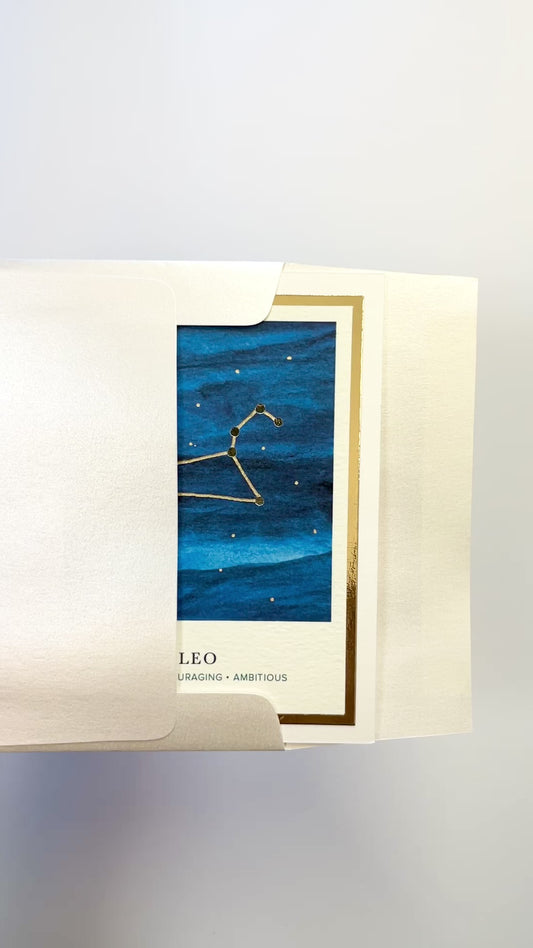 Handmade Leo zodiac constellation card with watercolor background and gold foil, blank inside on premium FSC-certified cardstock.