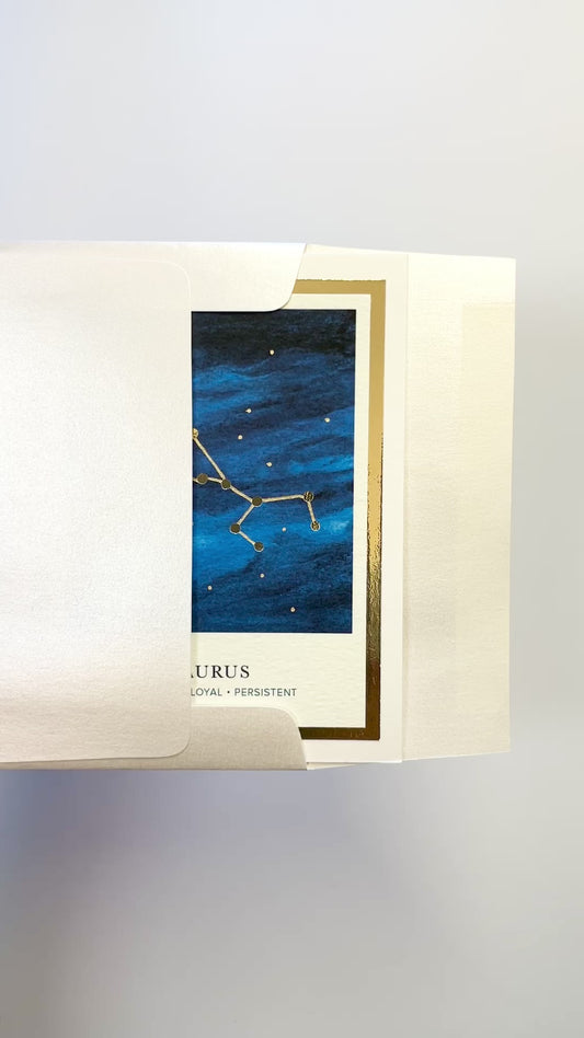Handmade Taurus zodiac constellation card with watercolor night sky and gold foil details, blank inside on premium FSC-certified cardstock.
