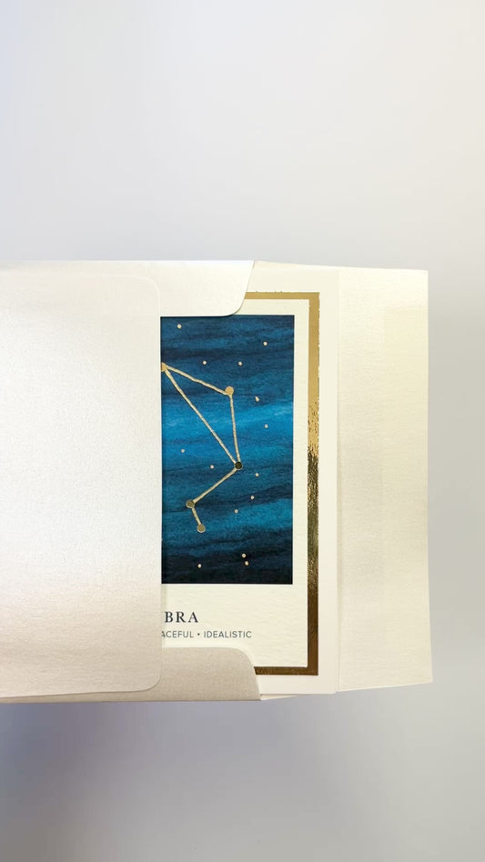 Handmade Libra zodiac constellation card with watercolor night sky and gold foil, blank inside on premium cardstock.