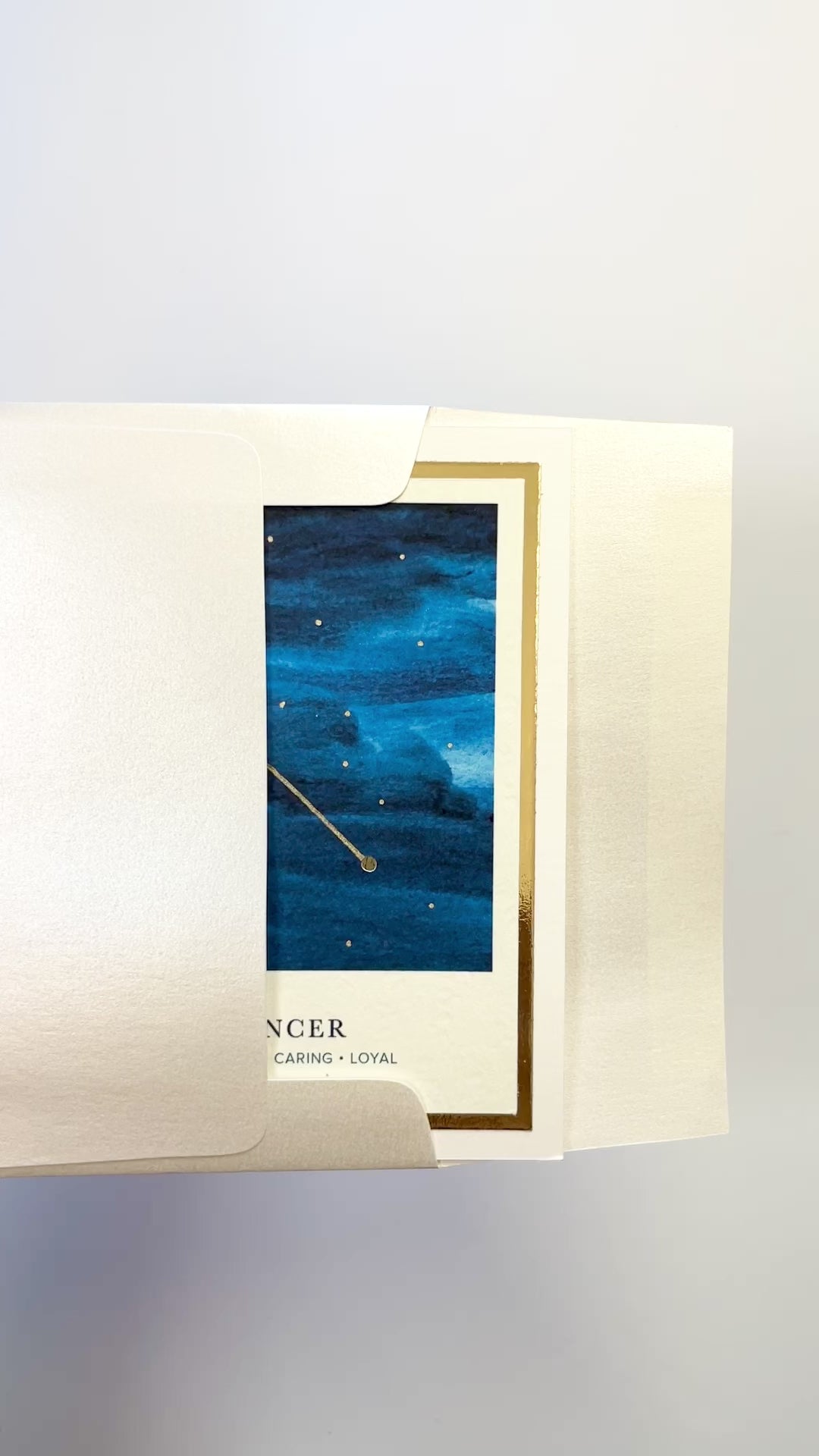 Handmade Cancer zodiac constellation card with watercolor night sky and gold foil details, blank inside on FSC-certified cardstock.