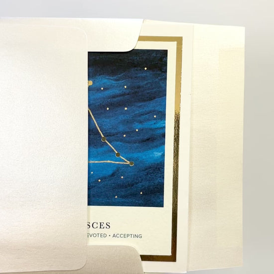 Handmade Pisces zodiac constellation card with watercolor sky and gold foil accents, blank inside on FSC-certified cardstock.