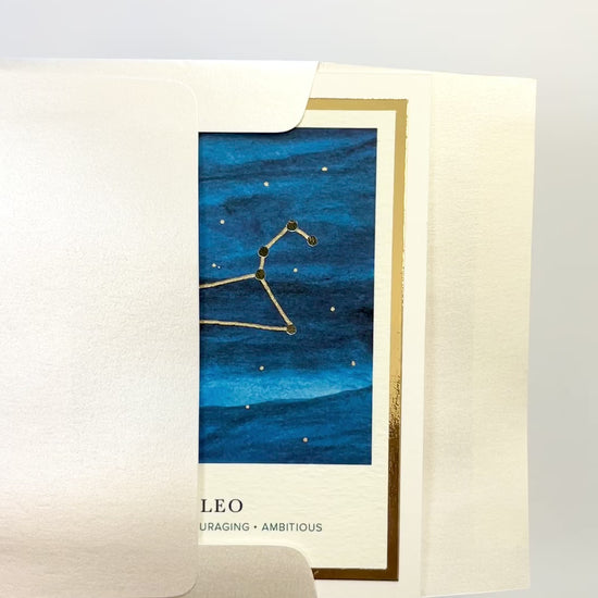 Handmade Leo zodiac constellation card with watercolor background and gold foil, blank inside on premium FSC-certified cardstock.