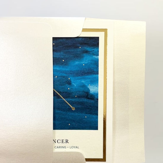 Handmade Cancer zodiac constellation card with watercolor night sky and gold foil details, blank inside on FSC-certified cardstock.